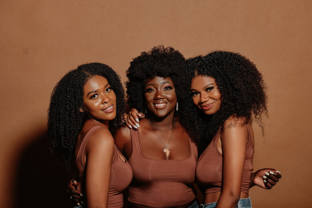 3 women with natural hair posing 